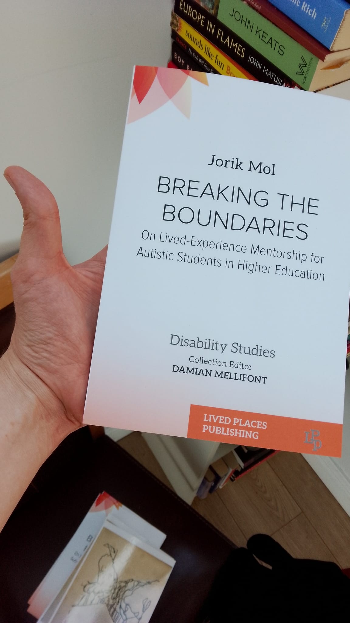An image of Jorik, holding a copy of Breaking the Boundaries, and a raised thumb.